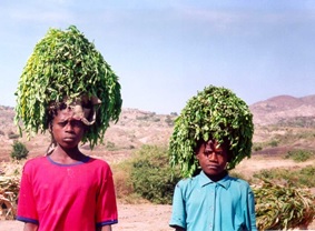 Two woman wearing moringa leaves